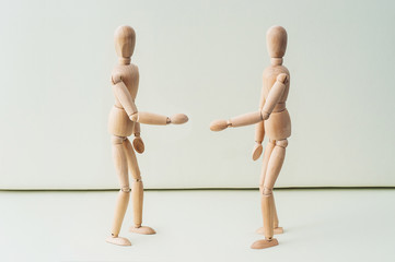 Wooden dummy with hands on hips on grey backgroundToilet paper and wooden man on yellow background, space for text