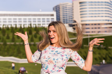 Portrait of happy funny cheerful smiling young beautiful blond woman outdoor. Summer and people concept.