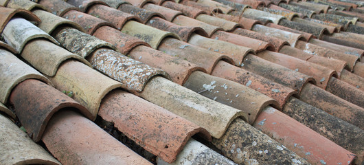Tiles on old castle roof, architecture background. Brown roof tiles.