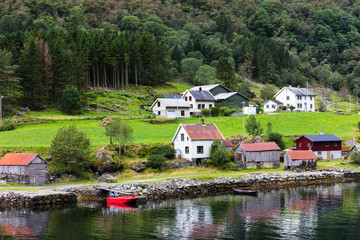 Fototapeta na wymiar Reflection of houses in a norwegian fjord