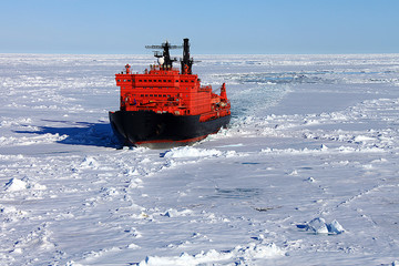 Red icebreaker in the middle of Arctic ocean