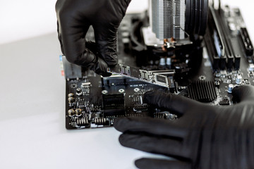 Computer components at the time of PC assembly. Installation ssd-m2. Motherboard, RAM, cooling system, SSD drive