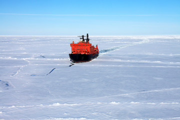 Red icebreaker in the middle of Arctic ocean