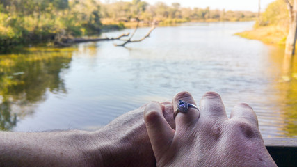 Caucasian couple celebrating engagement at waterside, Kruger National Park, South Africa