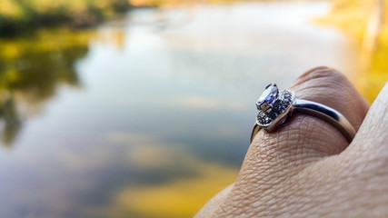 Close up caucasian woman hand with engagement ring at waterside, Kruger National Park, South Africa