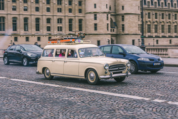 classic 403 break, old and french family car. Rolling through the center of the capital