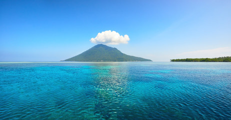 Beautiful panoramic view of volcanic island of Manado Tua on summer day. North Sulawesi, Indonesia