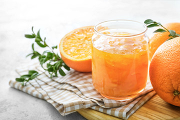Jar of orange jam on table