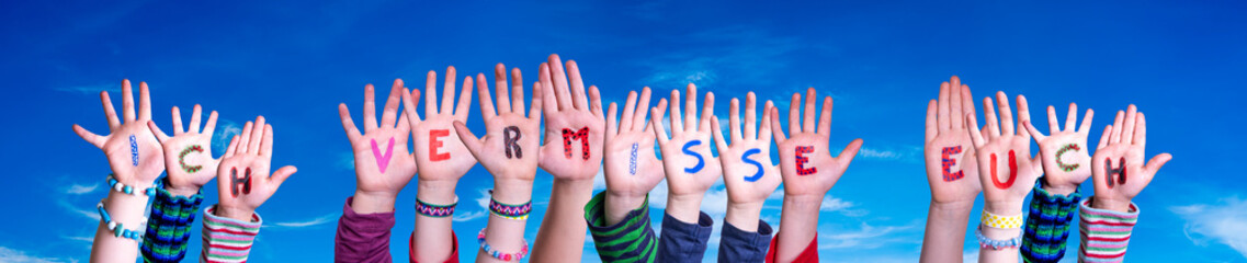 Children Hands Building Colorful German Word Ich Vermisse Euch Means I Miss You. Blue Sky As Background