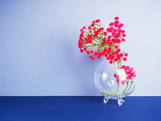 artificial flowers transparent vase. Closeup artificial colorful flower on transparent glass bottle