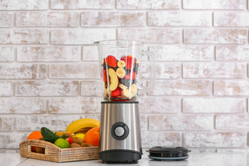 Modern blender and ingredients for healthy smoothie on kitchen table