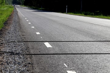 Vehicle Traffic counter on the road. Black Rubber Tubes
