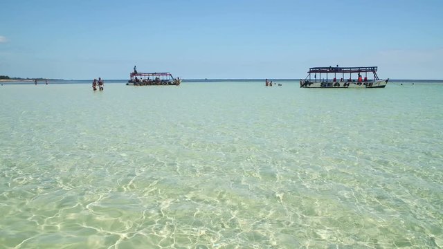 Landscape view of few boats on a clear ocean water in Watamu Beach, Kenya, Africa
