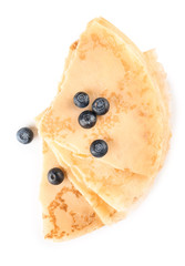 Tasty blini with berries on white background
