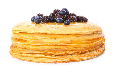 Tasty blini with berries on white background