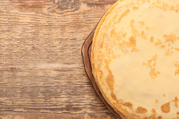 Tasty blini on wooden background
