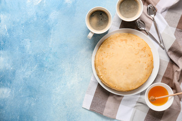 Tasty blini with honey and coffee on color background