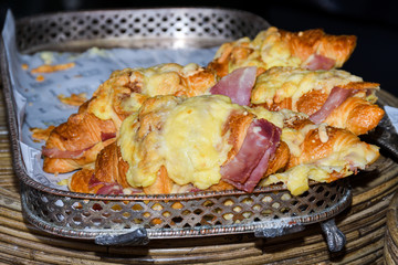 Close-up fresh croissant with ham and cheese