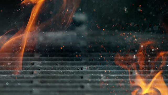 Cast iron grate with Fire flames and sparkles, shooting on high speed camera at 1000fps