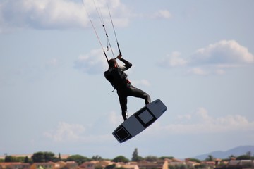 white man in jumping on kitesurf on a white sky background