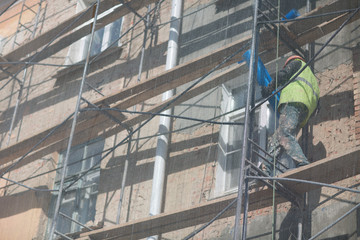 Worker on Scaffolding on building in the city