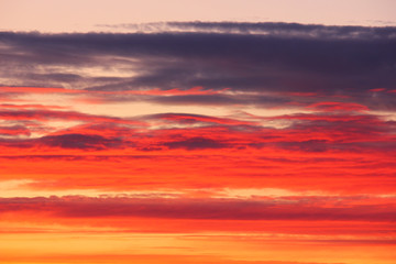 red-orange clouds in the sky after sunset