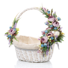Fototapeta na wymiar Wicker basket with fabric inside. Decorating a beautiful composition of blue and purple flowers. Isolated