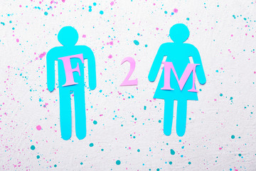 Male and female figures and abbreviation F2M on white background. Concept of transgender