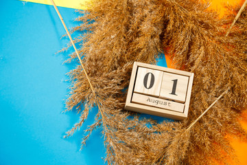 Calendar of wooden cubes with numbers and months. Choosing a number on a wooden calendar. August 1. Date august