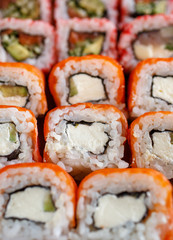 Sushi rolls of japanese food in restaurant. Sushi rolls set with salmon, vegetables and caviar closeup. Japanese restaurant menu