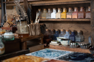color painter artist's workspace, water color tools on desk of painter.