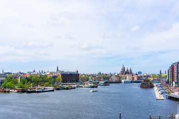 Typical canal in the center of Amsterdam. Visible are restaurants, sightseeing tourism boats at...