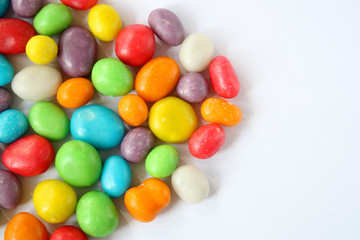 Multi-colored dragees, sweet candies in the glaze. The atmosphere of the holiday. Raisins in a sweet bright shell.