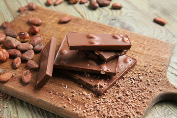 Sweet chocolate with nuts on wooden board