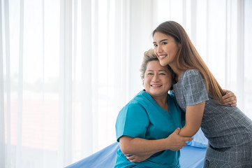 The daughter visits the grandmother who is sick in the hospital.