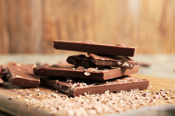 Sweet chocolate with nuts on wooden board