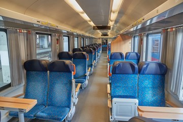 Interior of a passenger train with empty seats, no people during quarantine lockdowns