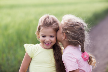Two little girls in a field portrait