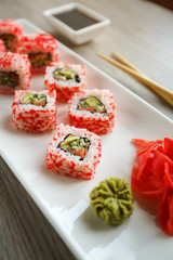 Roll with salmon, cucumber, avocado and caviar for sushi lovers. Japanese and Chinese cuisine.