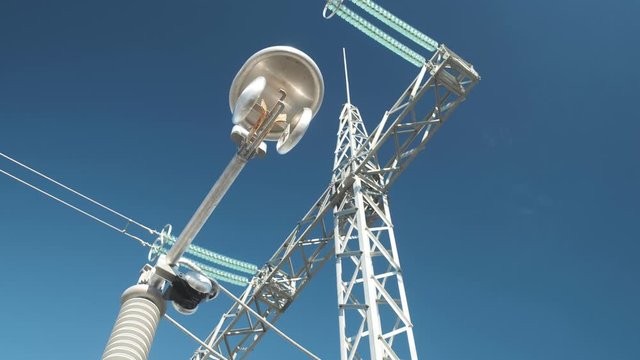 high voltage substation disconnector knife against metal structures and blue sky