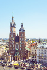 Fototapeta na wymiar Beautiful view on Krakow famous landmark - St. Mary's Basilica (Mariacki Gothic Church)and Old Town of Krakow, made from the viewpoint on Town Hall. Travel concept