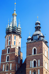 Close up view on towers of Krakow famous landmark - St. Mary's Basilica (Mariacki Roman Catholic Gothic Church). Built in 13-14th century. Travel and religious concept