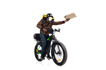 Naklejka premium Too much orders. Contacless delivery service during quarantine. Man delivers food during isolation, wearing helmet and face mask. Taking food on bike isolated on white background. Safety. Hurrying up.
