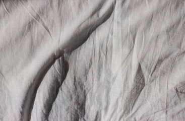 Texture of crumpled natural white linen fabric