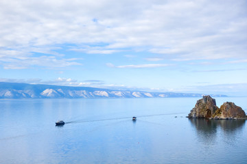 Two pleasure tourist boats sail on the water of Lake Baikal. Cape Burhan near the island of Olkhon, Russia.