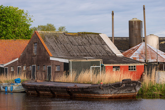 Costruzioni rurali con chiatta su un canale navigabile