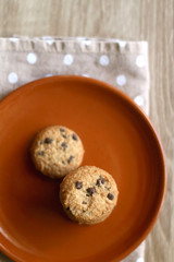 Chocolate chip cookies and polka dot napkin on wooden table. Top view.