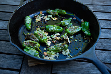 snack paprika with garlic and onions in a cast-iron pan as a delicious side dish for grilling