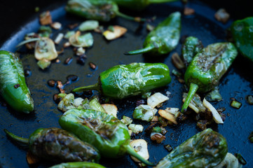 snack paprika with garlic and onions in a cast-iron pan as a delicious side dish for grilling