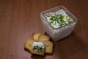 Plain curd or yogurt or dahi in transparent glass bowl and toast top view - wood background 2